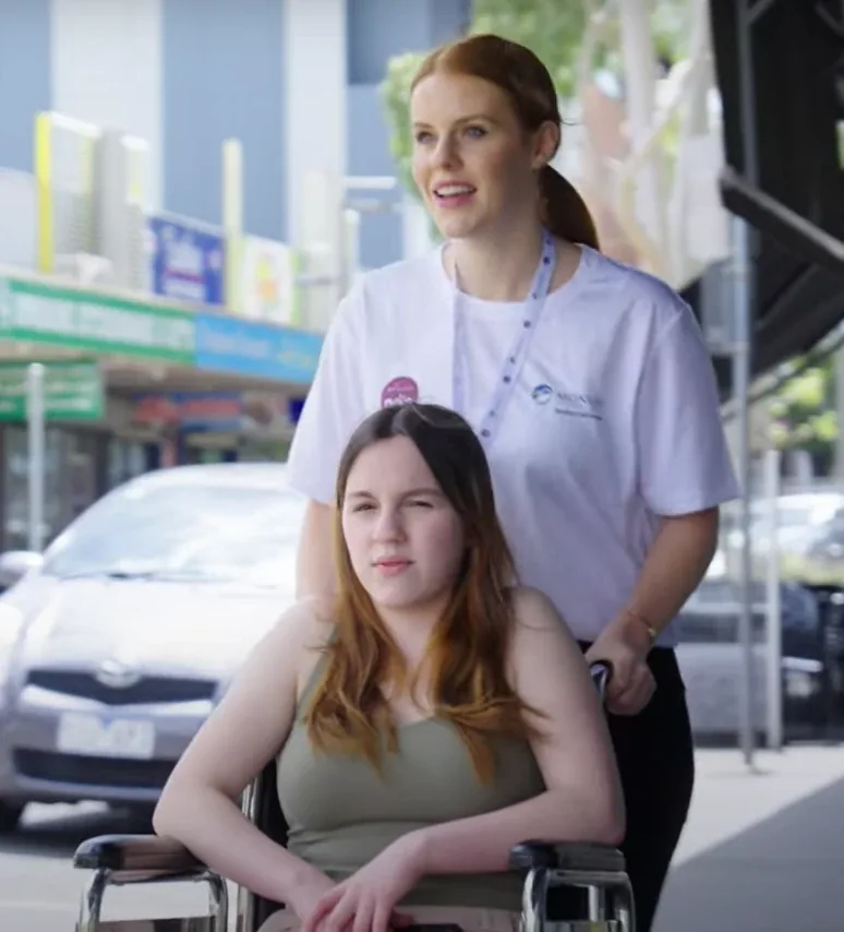 A Monash Care support worker out in the community with a participant